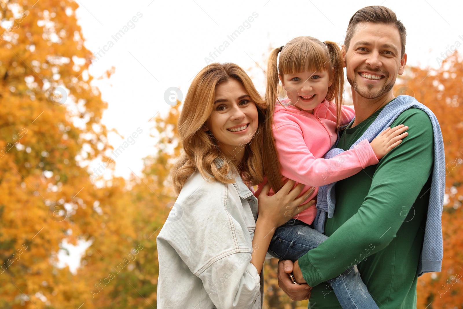 Photo of Happy family with child together in park. Autumn walk