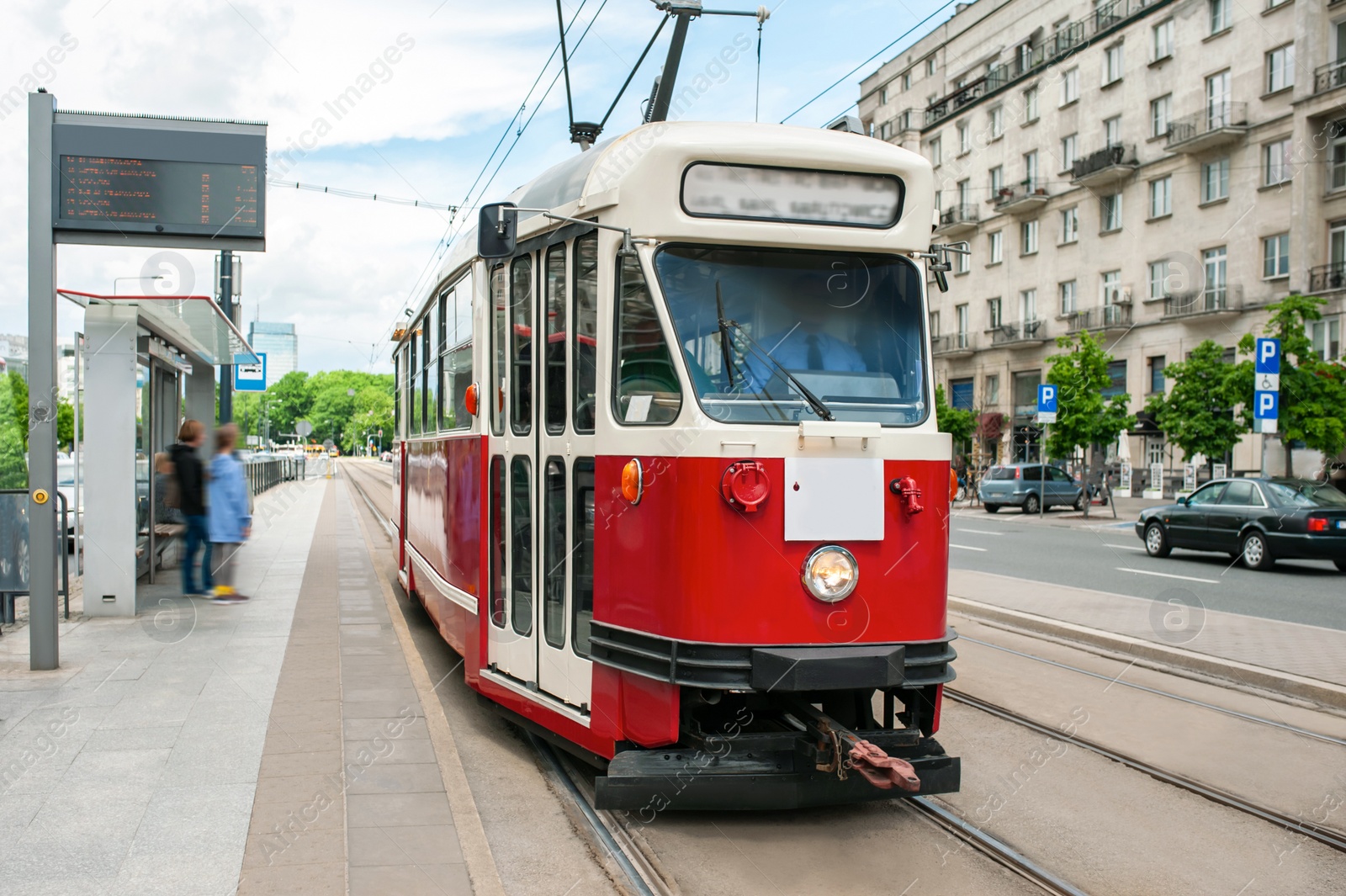 Photo of Beautiful tram on railroad near building outdoors