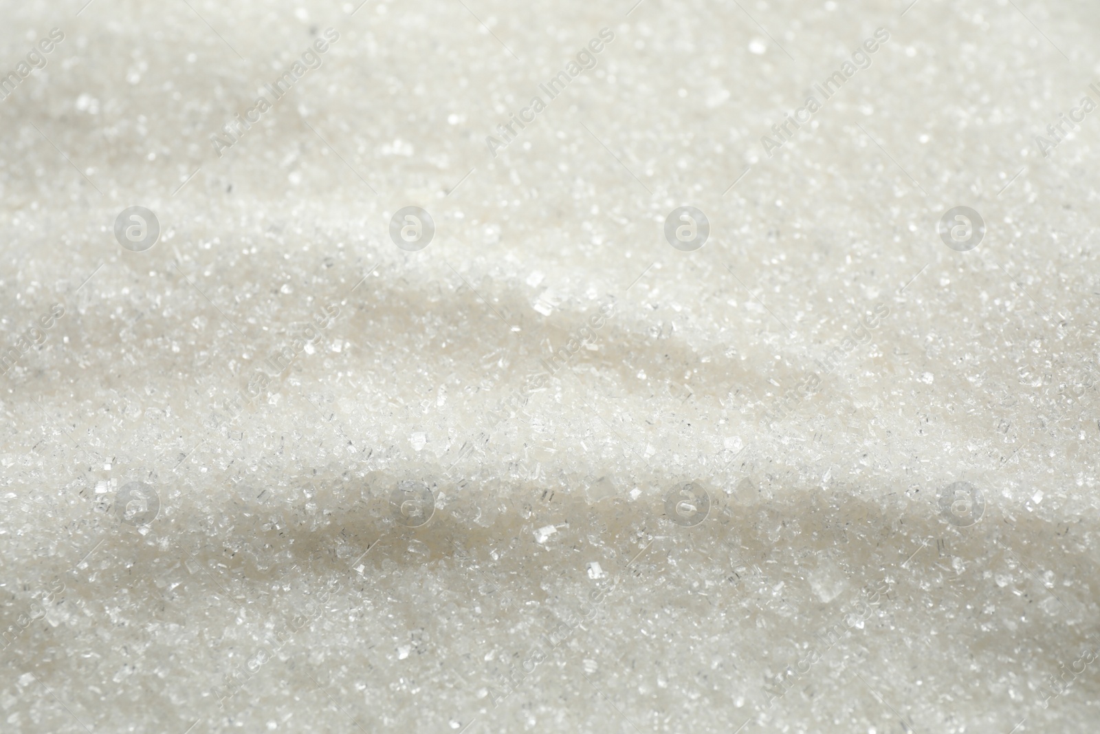 Photo of Pile of granulated sugar as background, closeup