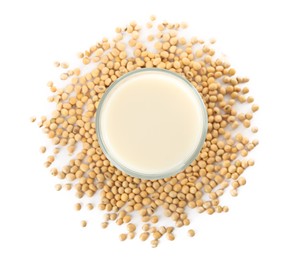 Glass of fresh soy milk and beans on white background, top view