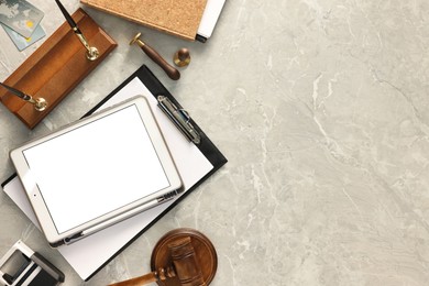 Photo of Flat lay composition with modern tablet on gray marble table. Space for text