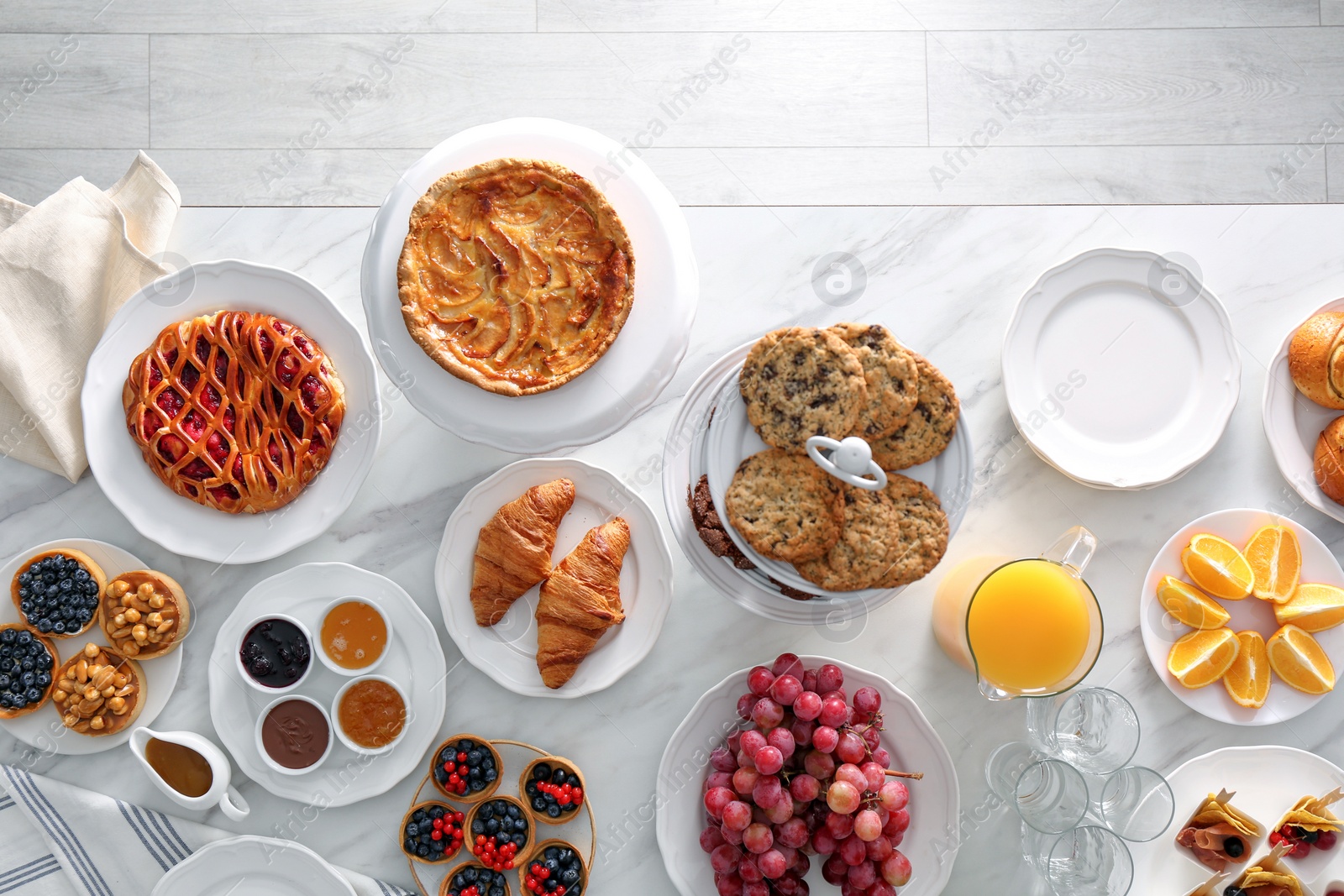 Photo of Variety of snacks on white marble table in buffet style indoors, flat lay