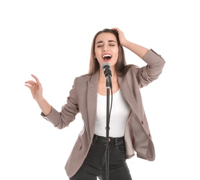 Young stylish woman singing in microphone on white background