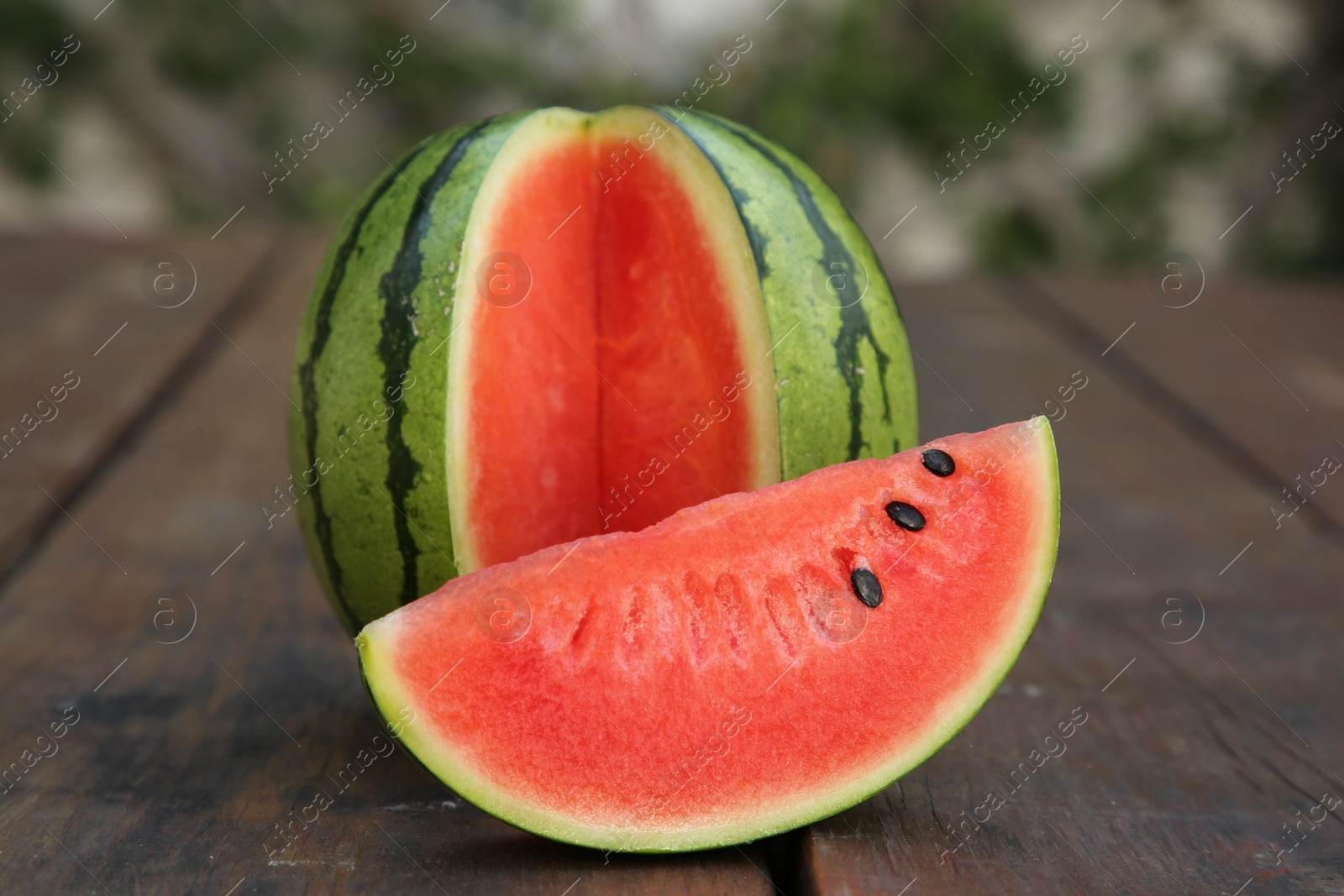 Photo of Delicious cut ripe watermelons on wooden table
