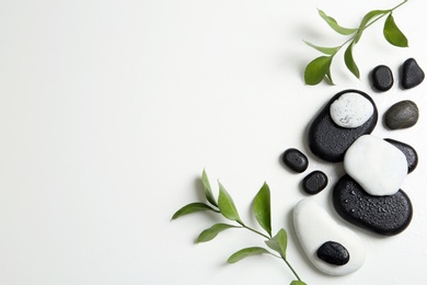 Photo of Flat lay composition with spa stones and space for text on white background