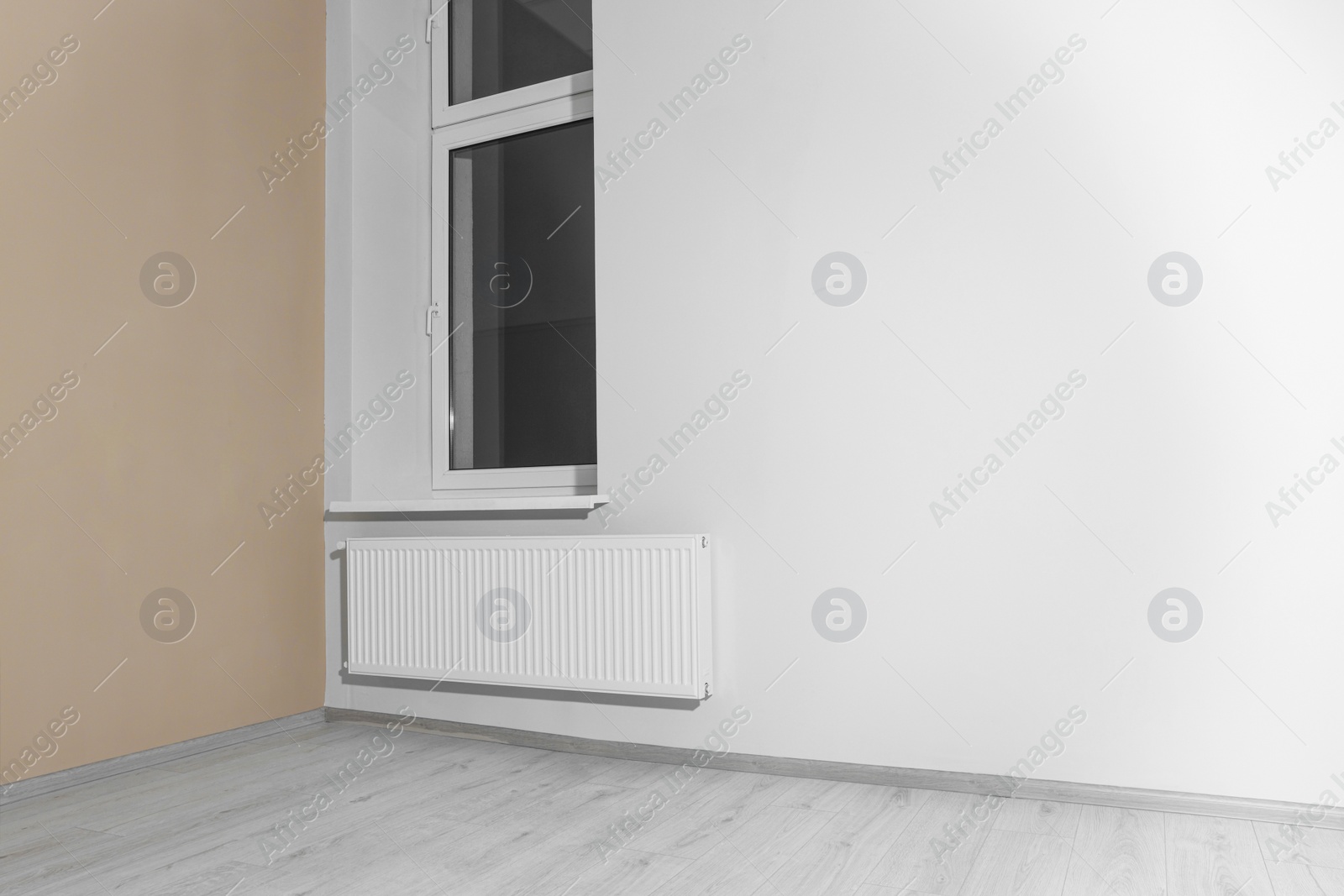 Photo of New empty room with clean window and light walls