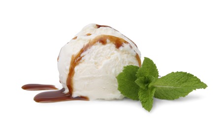 Photo of Scoop of ice cream with caramel sauce and mint isolated on white