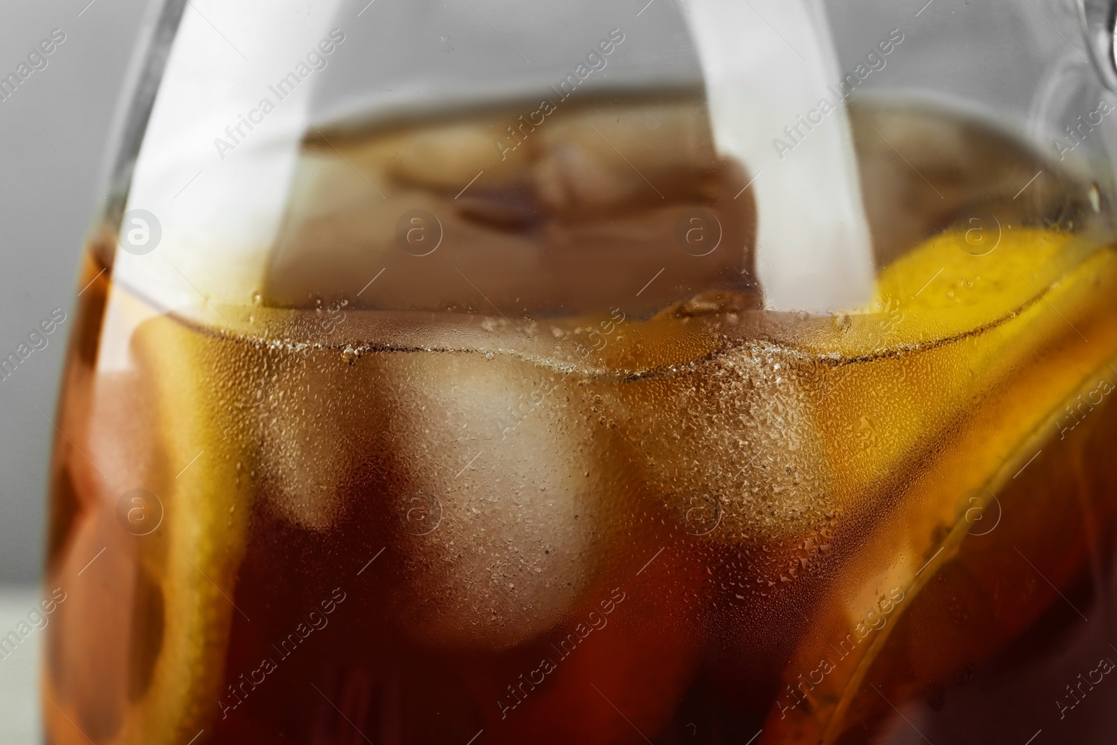 Photo of Glassware of delicious refreshing iced tea, closeup