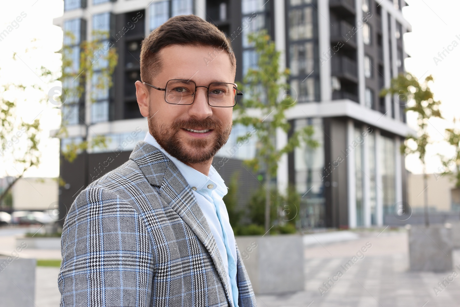 Photo of Portrait of handsome bearded man in glasses outdoors, space for text