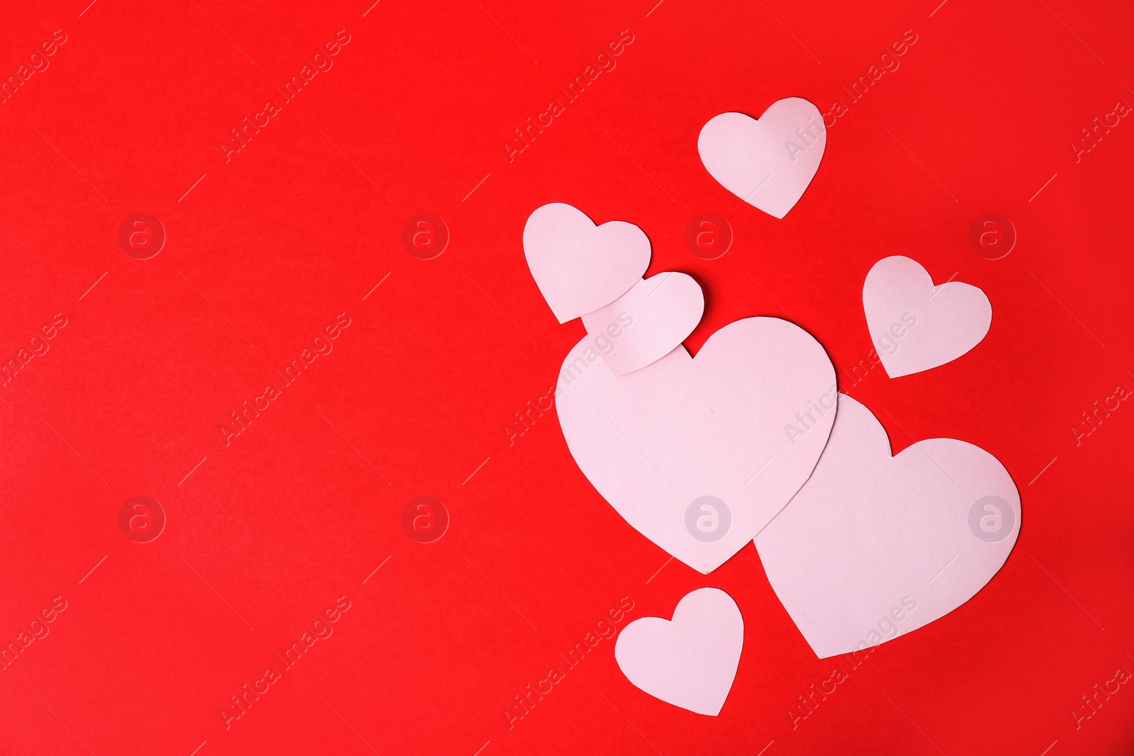 Photo of Paper hearts and space for text on color background, top view