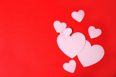 Photo of Paper hearts and space for text on color background, top view