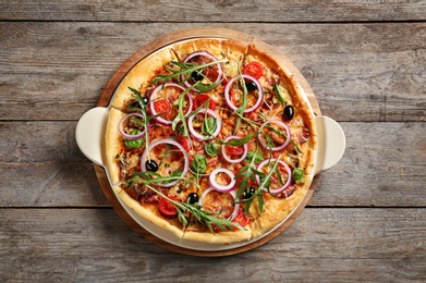 Photo of Tasty homemade pizza on wooden table, top view