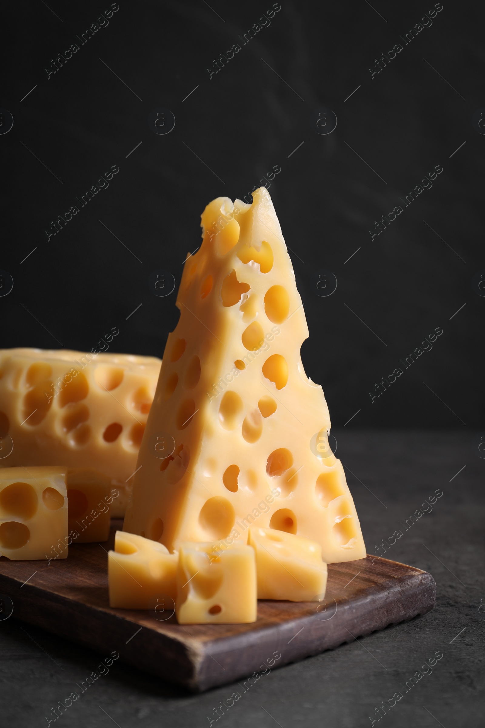 Photo of Tasty fresh cheese on dark grey table