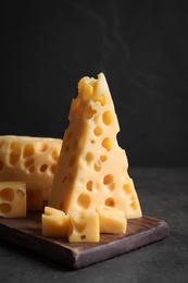 Tasty fresh cheese on dark grey table