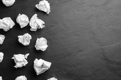 Photo of Crumpled sheets of paper on black background, flat lay. Space for text