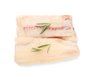 Photo of Pieces of raw cod fish and rosemary isolated on white