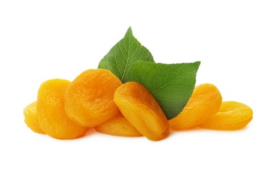 Photo of Pile of tasty apricots and green leaves on white background. Dried fruits