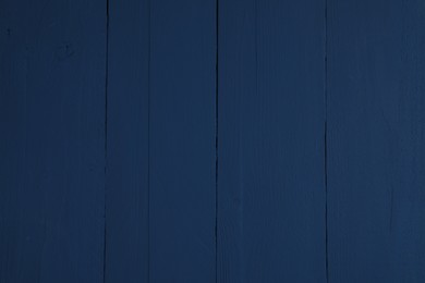 Texture of dark blue wooden surface as background, closeup