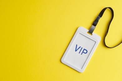 Photo of Vip badge on yellow background, top view. Space for text