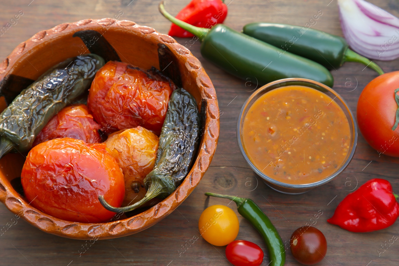 Photo of Tasty salsa sauce and ingredients on wooden table, flat lay