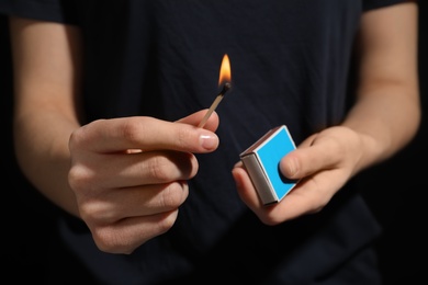Woman with box of matches, closeup of hands