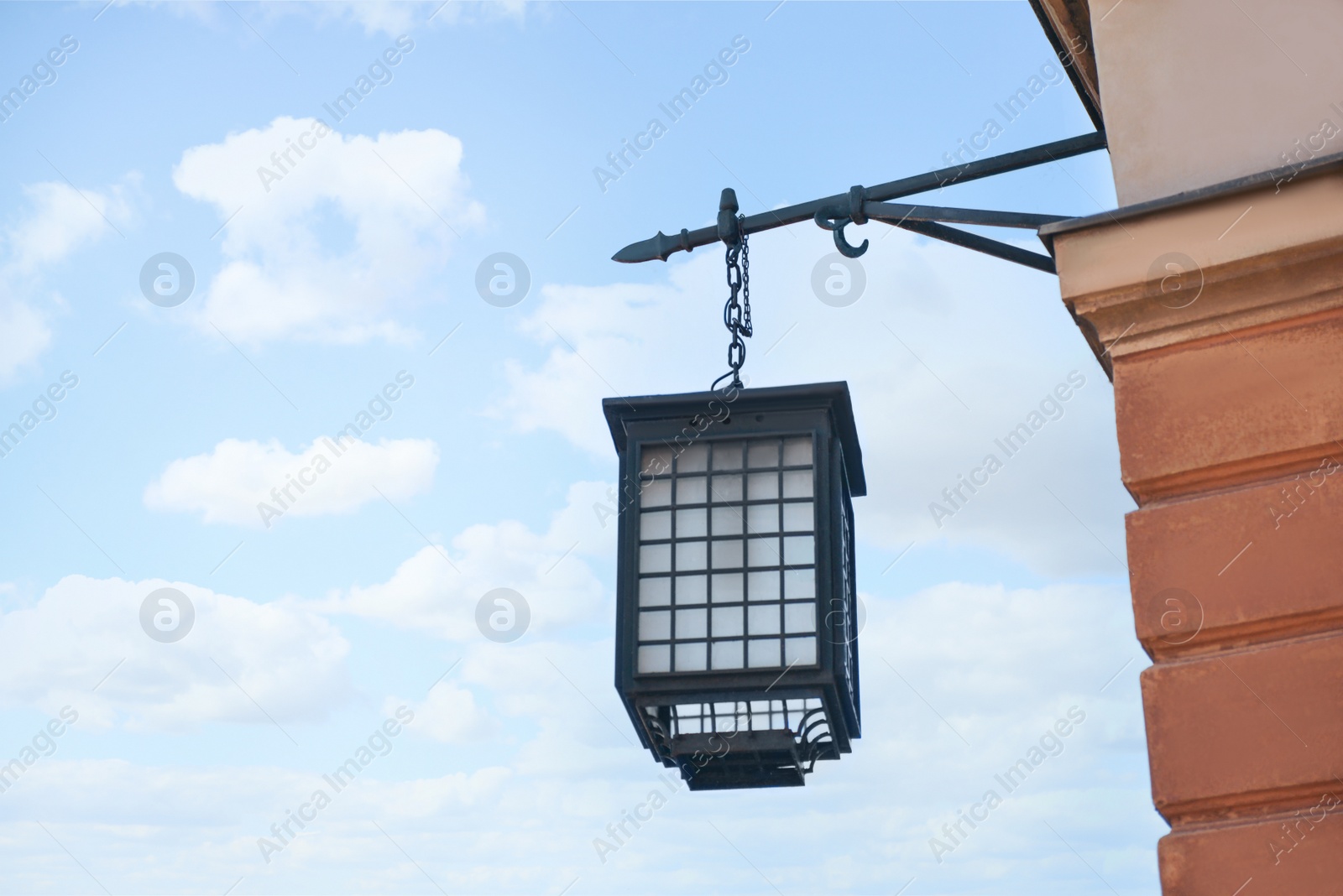 Photo of Beautiful vintage street lamp hanging on wall of building