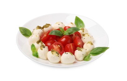 Plate of tasty Caprese salad with mozzarella, tomatoes, basil and pesto sauce isolated on white