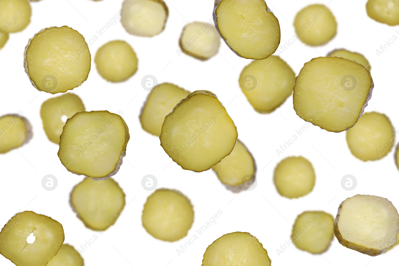 Image of Slices of tasty pickled cucumbers falling on white background