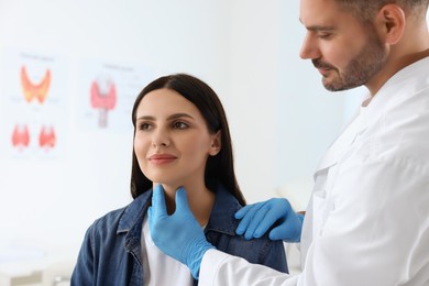 Photo of Endocrinologist examining thyroid gland of patient at hospital