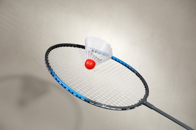 Photo of Shuttlecock and racquet on light background. Badminton equipment