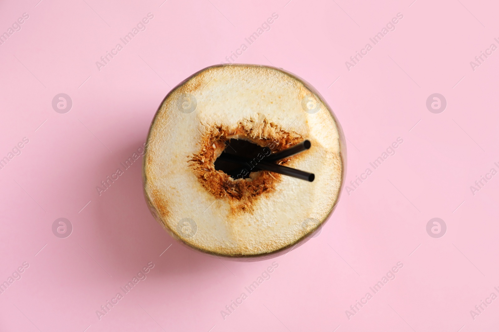 Photo of Fresh green coconut with drinking straws on color background