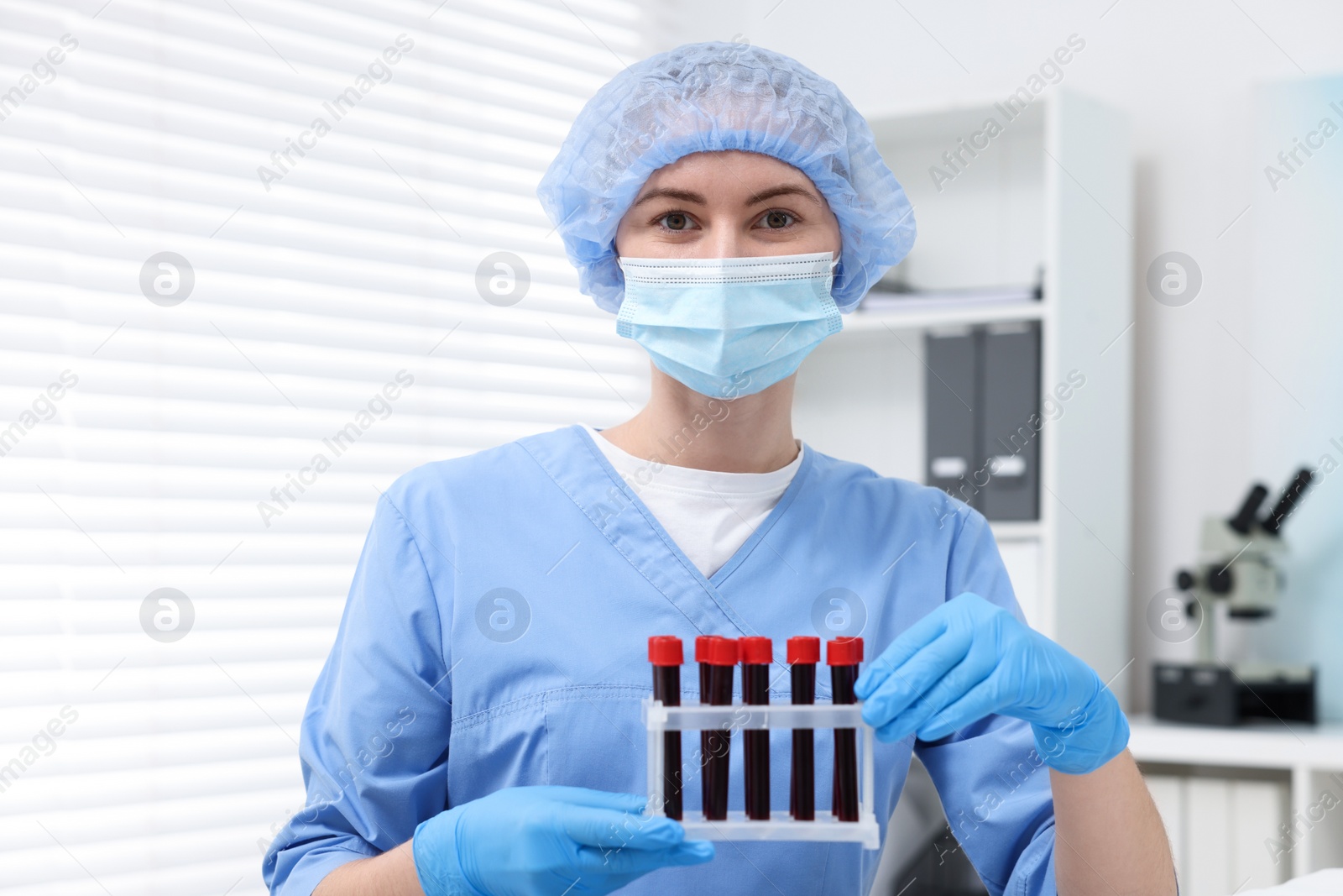 Photo of Laboratory testing. Doctor with blood samples in tubes at hospital