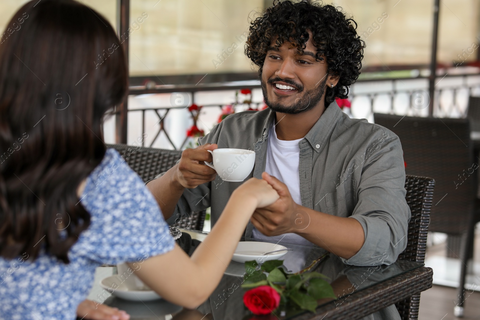 Photo of International dating. Happy couple spending time together in restaurant