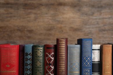 Photo of Stack of hardcover books on wooden background. Space for text