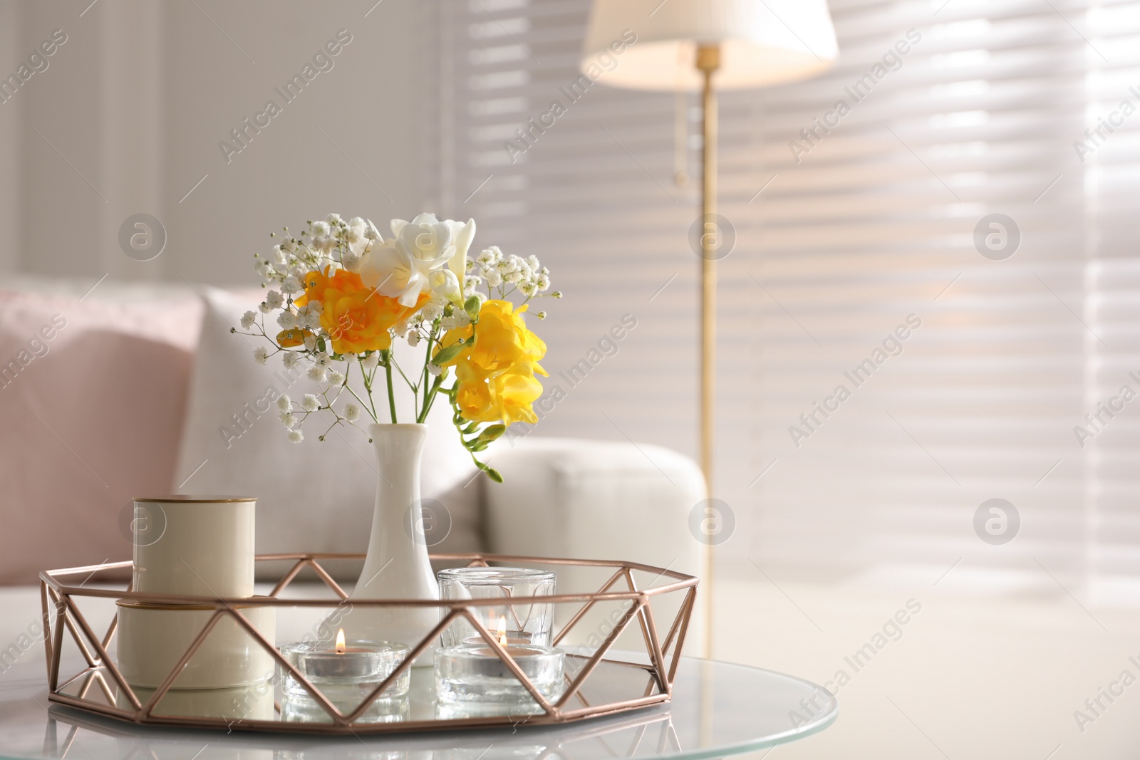 Photo of Beautiful bouquet with spring freesia flowers in light room, space for text