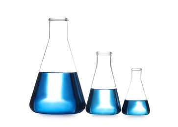 Photo of Conical flasks with blue liquid isolated on white. Laboratory glassware