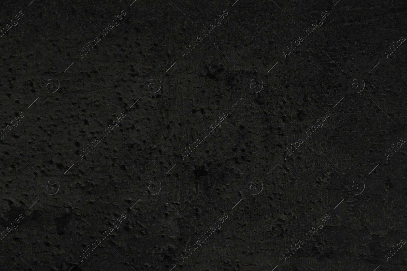 Photo of Texture of black stone surface as background, closeup