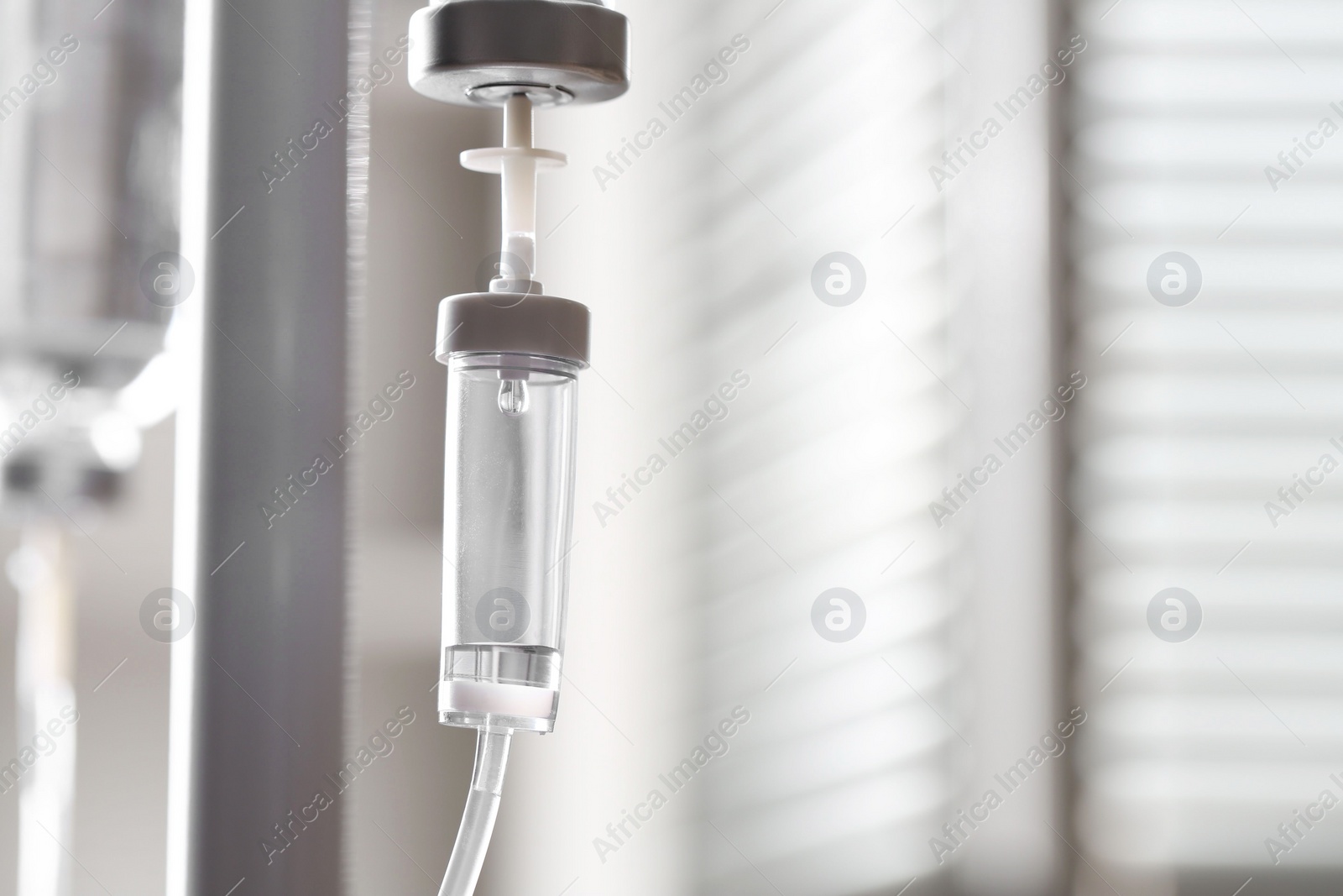 Photo of IV drip against blurred background, space for text