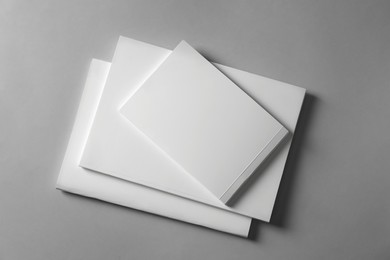 Photo of Brochures with blank covers on light grey background, top view