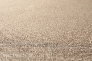 Texture of light brown fabric as background, closeup