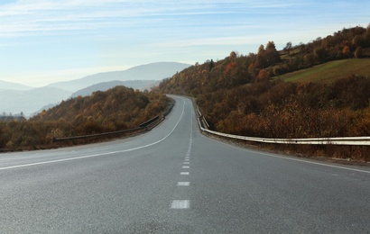 Landscape with asphalt road leading to mountains