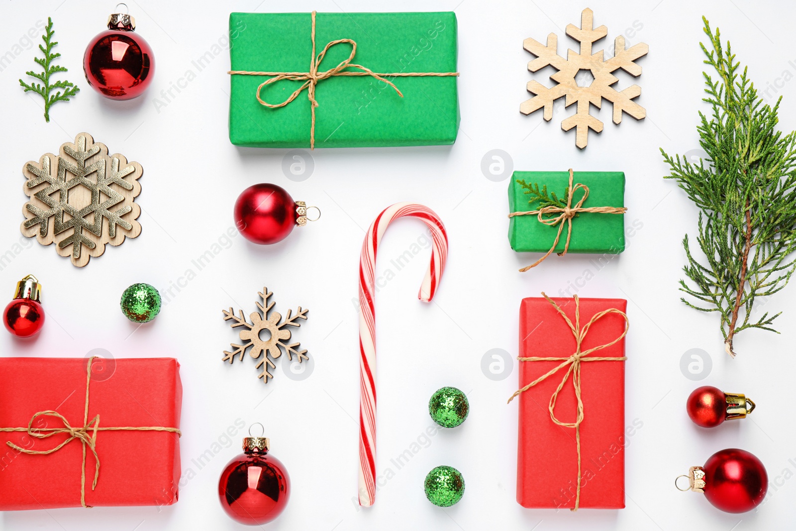 Photo of Flat lay composition with Christmas gifts and festive decor on white background