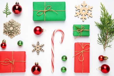 Flat lay composition with Christmas gifts and festive decor on white background