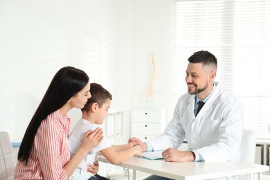 Little boy with mother visiting orthopedist at clinic