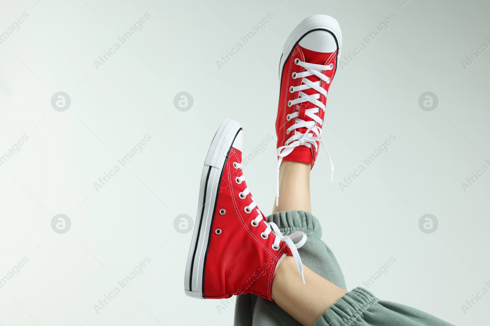 Photo of Woman in stylish gumshoes on white background, closeup. Space for text