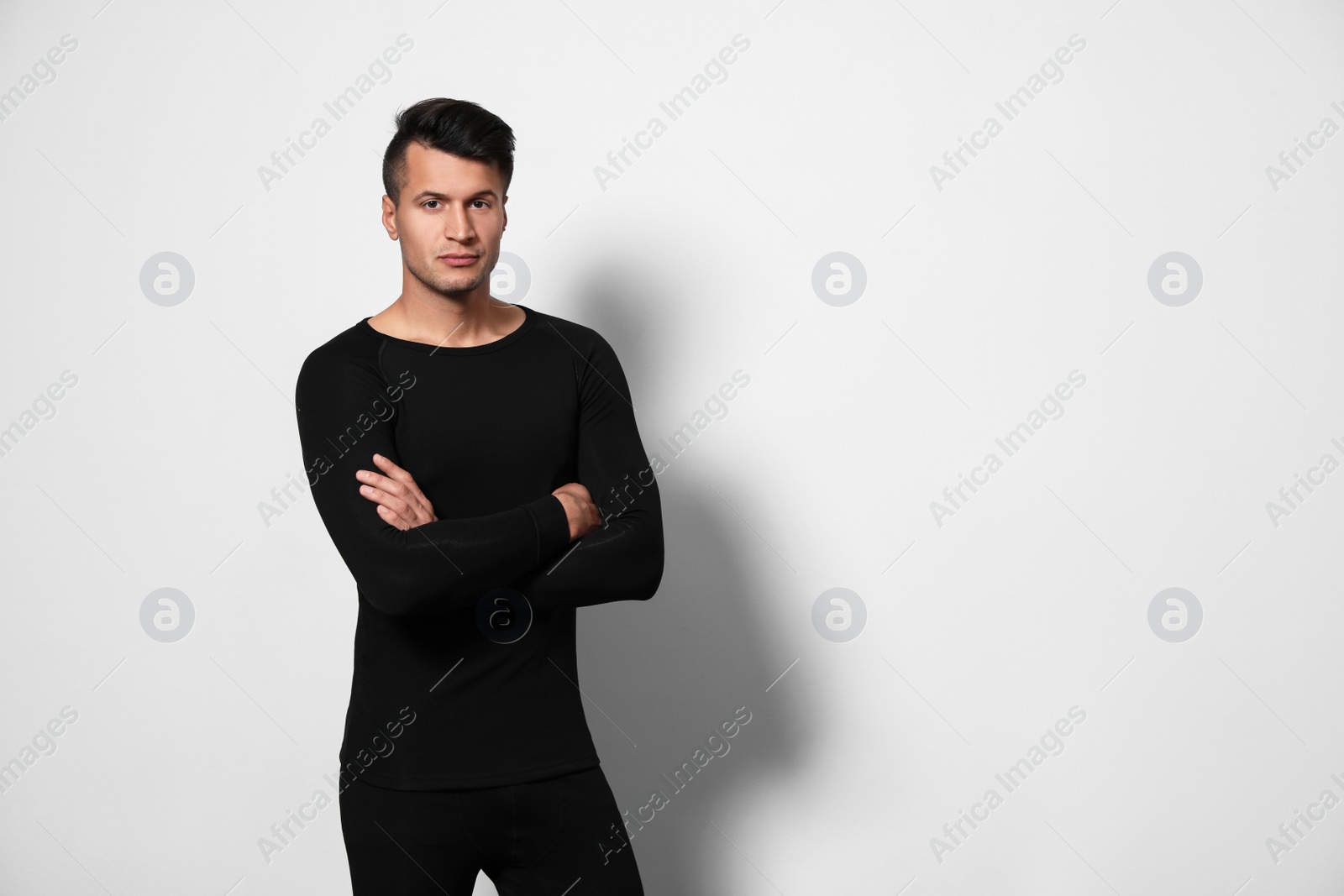 Photo of Man wearing thermal underwear on light grey background. Space for text