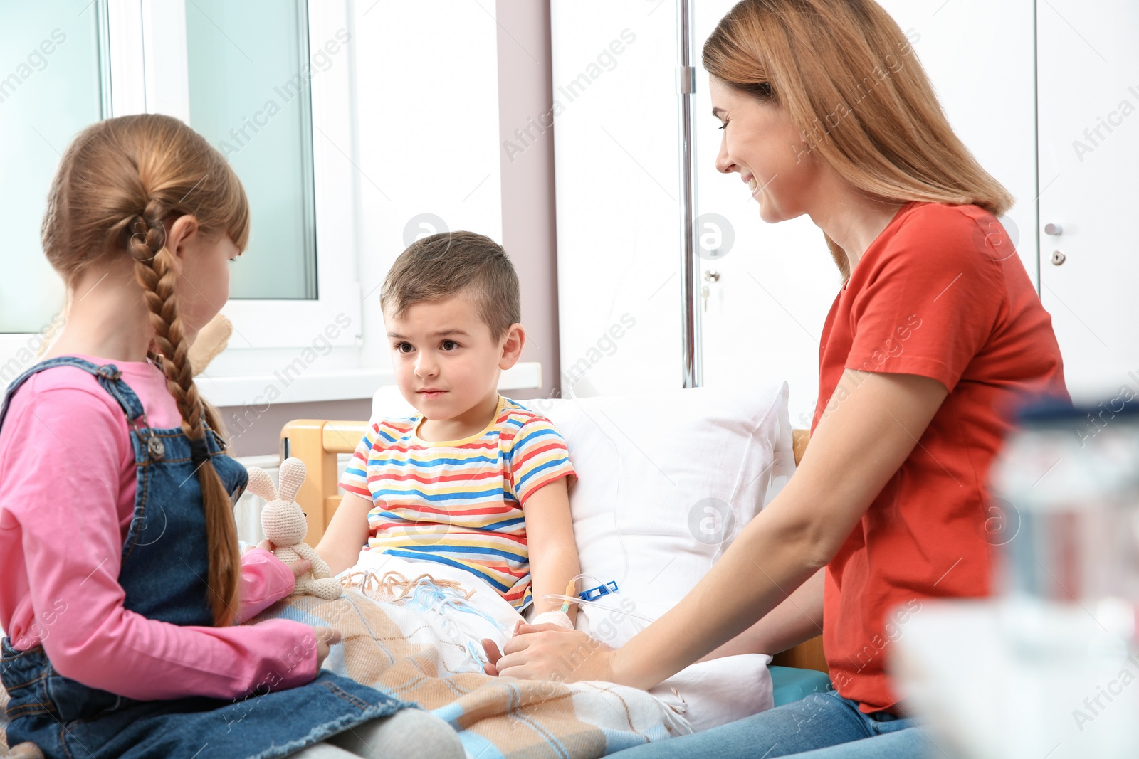 Photo of Happy family visiting little child in hospital