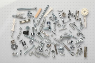 Many different fasteners on plastic surface, flat lay