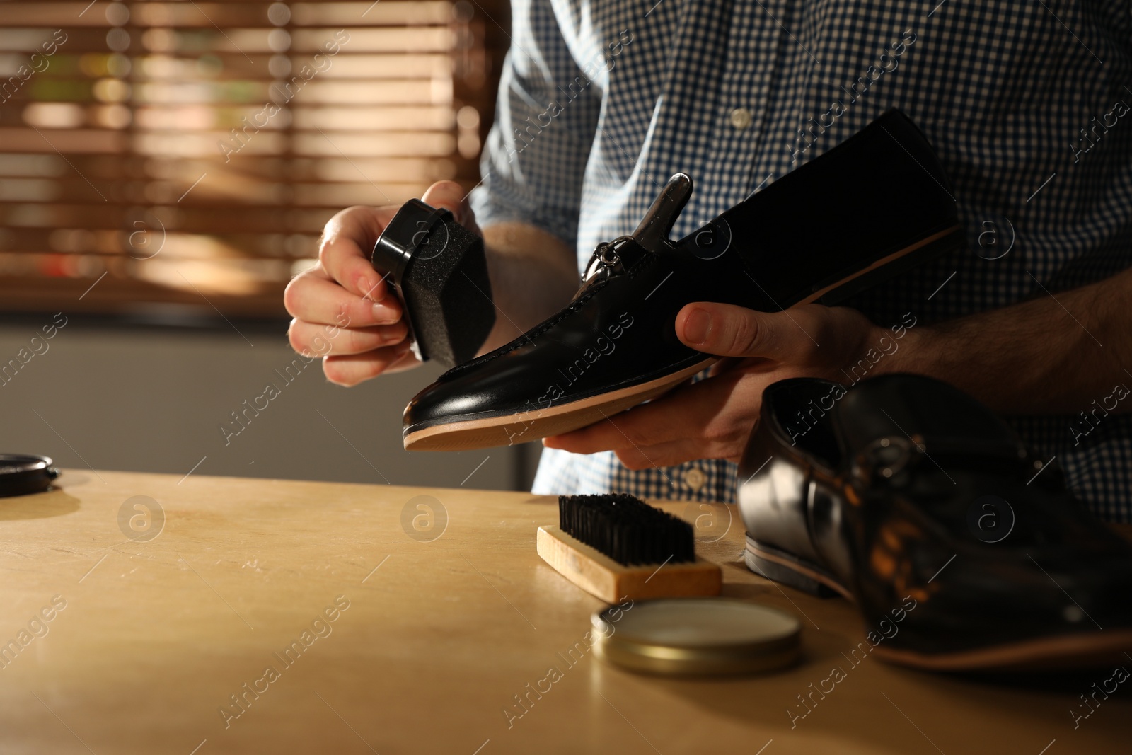 Photo of Master taking care of shoes in his workshop, closeup