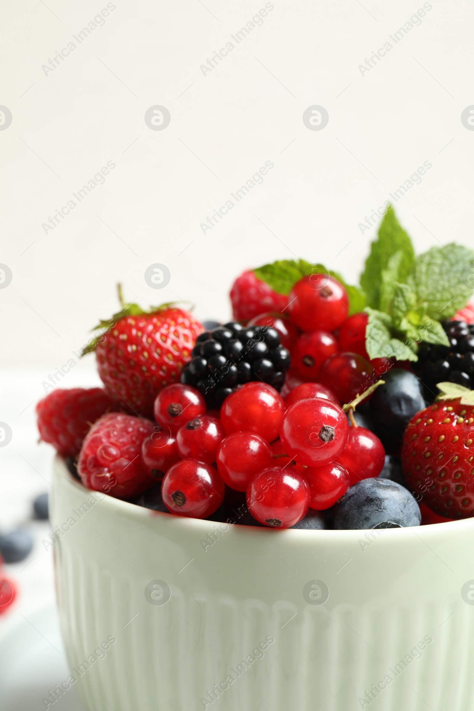 Photo of Mix of ripe berries in bowl, closeup